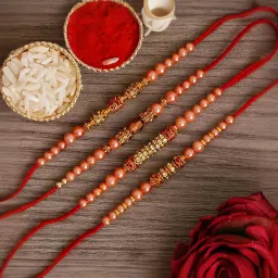 eCraftIndia Red & Golden Set of 4 Pearl Rakhis with Sibling Agreement & Roli Chawal Pack image 1