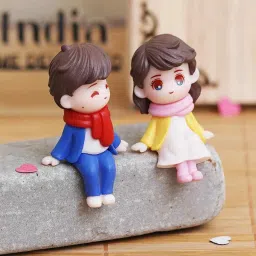 ecraftindia Cute Boy & Girl Sitting Multicolour Polyresin Showpieces image 1