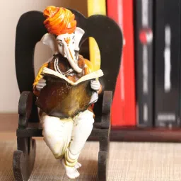 Orange Polyresin Lord Ganesha Reading Book On Wooden Chair Idol by eCraftIndia image 1